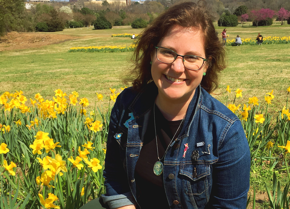 Mandy sitting in a field of daffodils